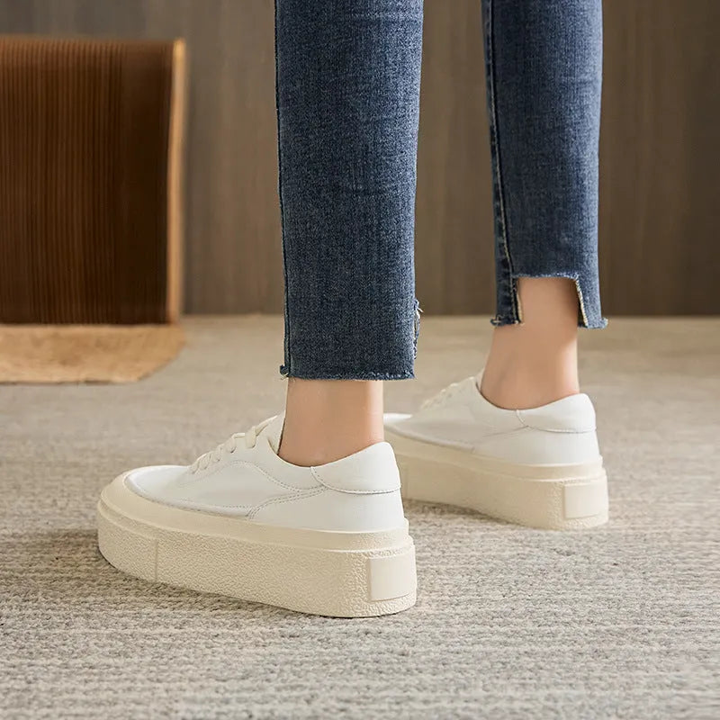 Women's black embossed cowhide leather platform sports board shoes with a round toe and white rubber sole.