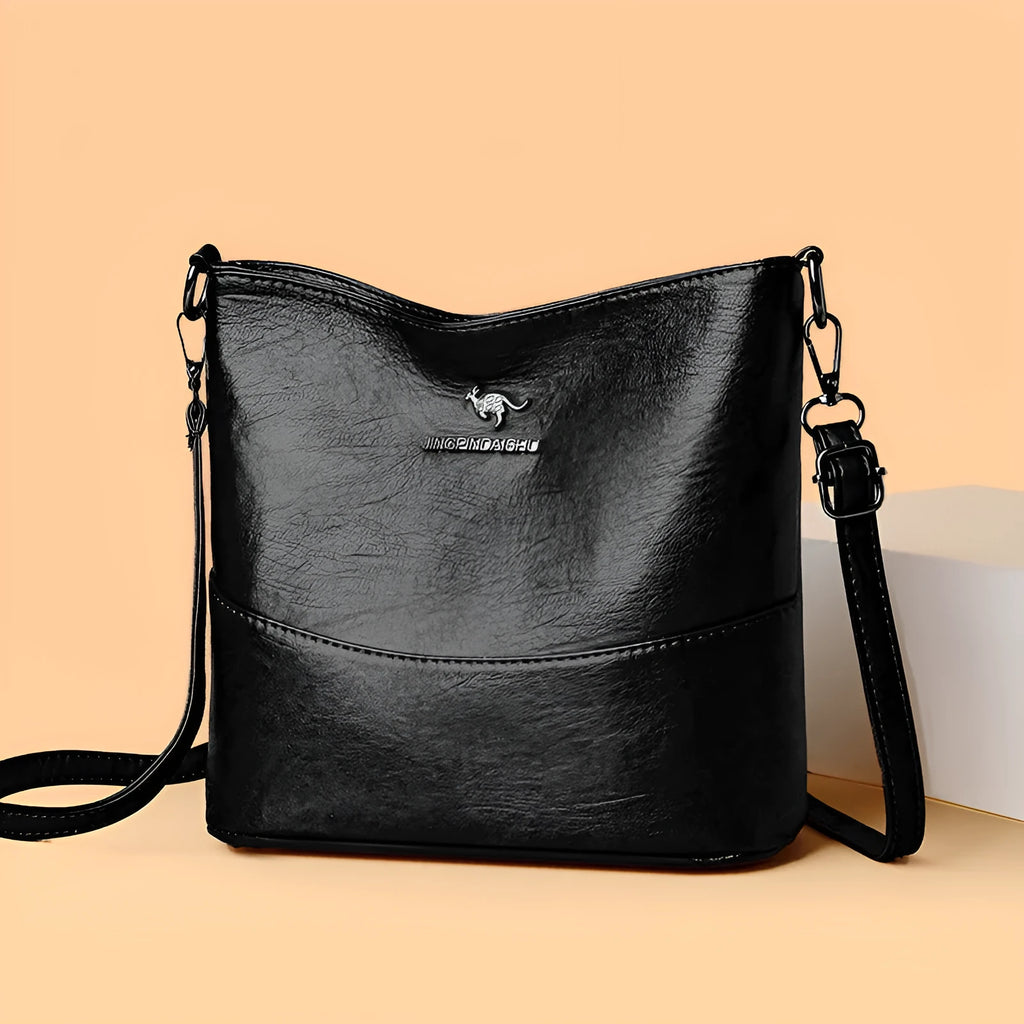 Women's black bucket-style leather shoulder bag with sewing line detailing and shoulder strap