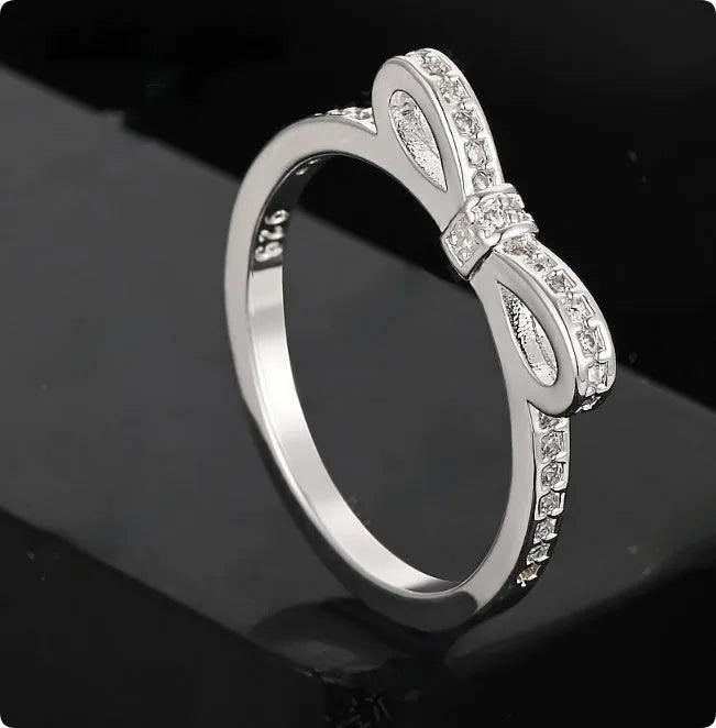 Silver couple's ring with bow design and zircon crystal rhinestones on sterling silver band