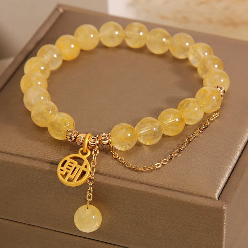 Natural citrine bracelet with Chinese character design and tassel detail