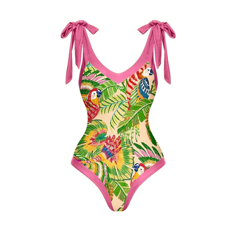 Pink floral retro one-piece swimsuit for women with V-neck and attached skirt on a hanger.