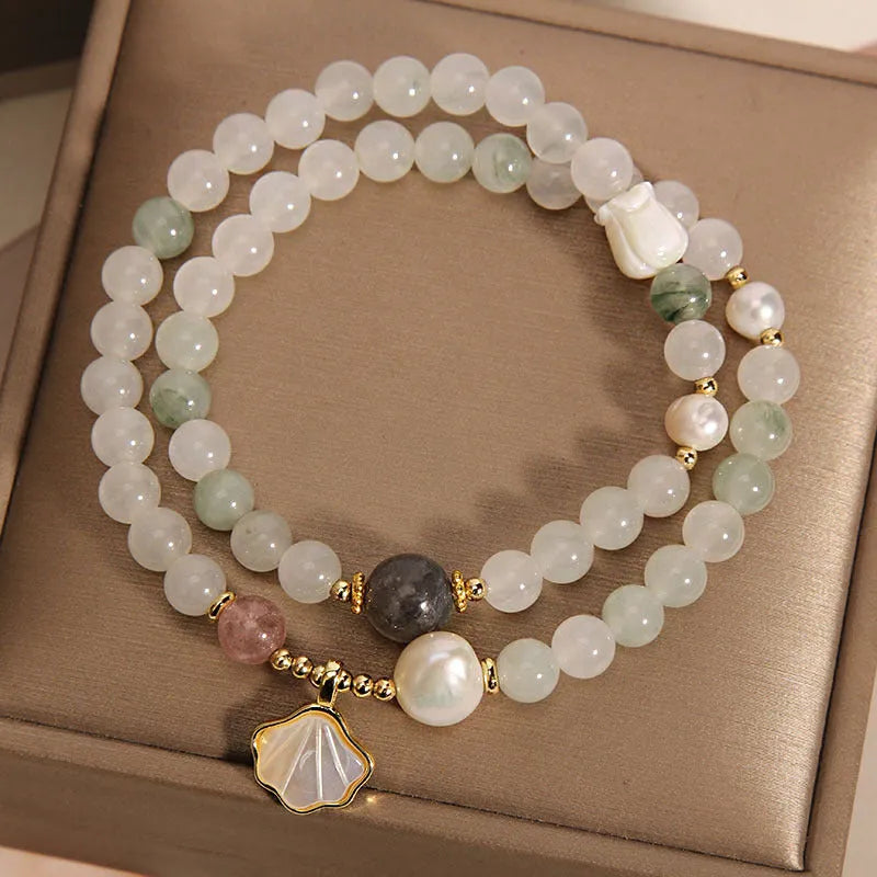 Women's crystal bracelet with a gold-plated ginkgo leaf pendant and rhinestone details.