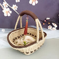 Hand-woven straw basket with hemp rope detailing in rustic farmhouse style