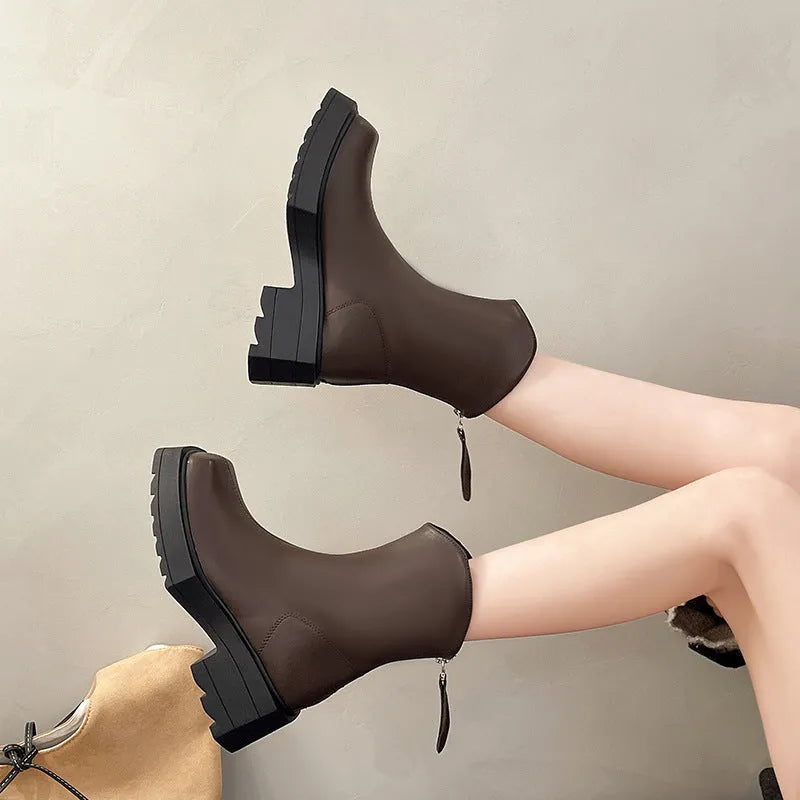Black platform Martin ankle boots for women with a square toe and back zipper on a white background.