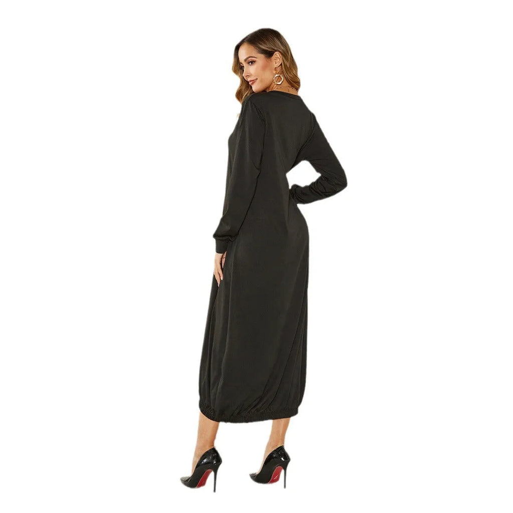 Loose black lantern dress with lace-up crew neck and long sleeves, laid flat.