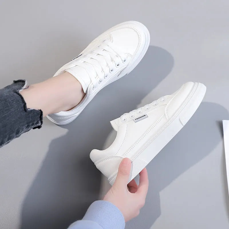 Korean style white low top PU sneakers for women on a plain background