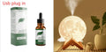 Spherical white Lunar humidifier night light with USB charging port and essential oil bottle