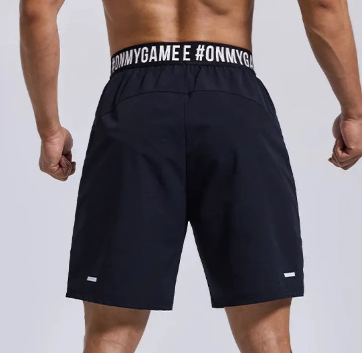 Men's loose fit sports shorts with elastic fly opening and letter details