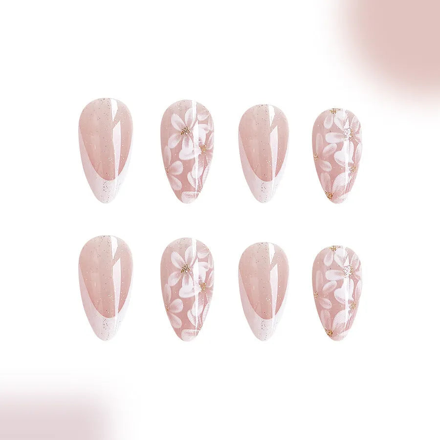 Short glossy almond-shaped false nails with glitter and flower French tip design, colour C625.