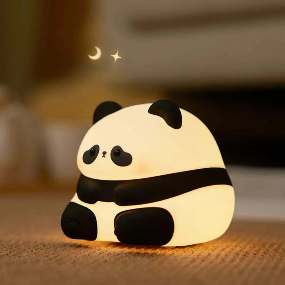 Cartoon panda night light with soft white glow on bedroom bedside table
