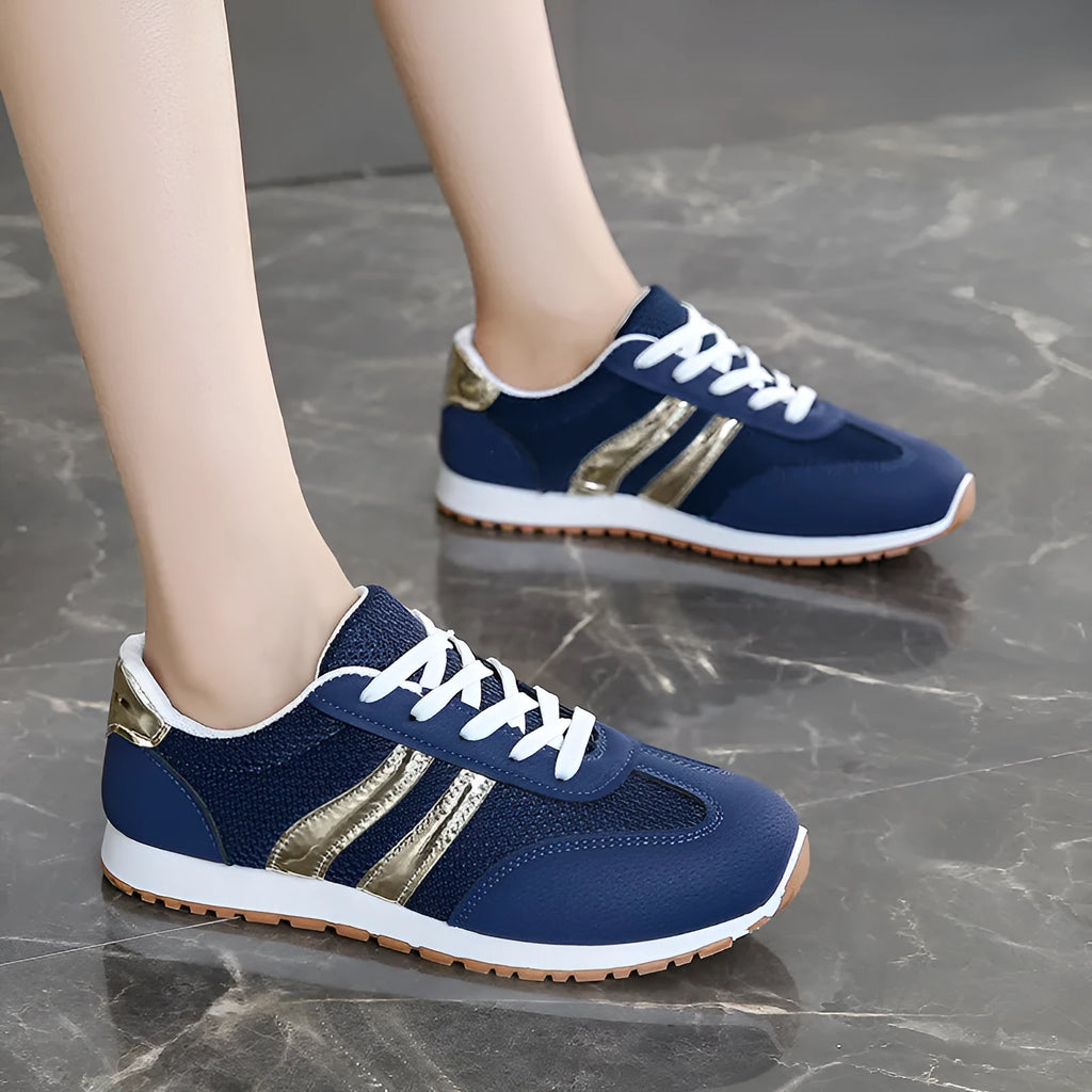 Blue women's casual tennis shoes with cross shoulder straps and white rubber sole.