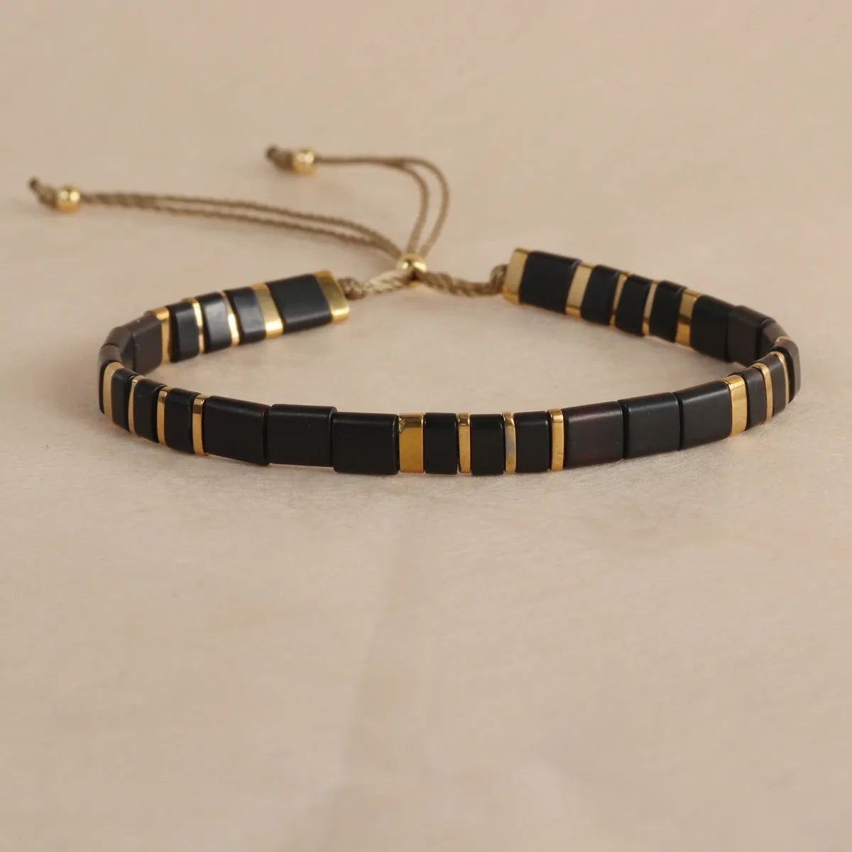 Adjustable glass beaded bracelet in geometric design with round beads available in five colours