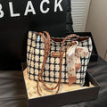 Black woolen shoulder bag with weaving details showing sandwich pocket exterior and interior organisation compartments