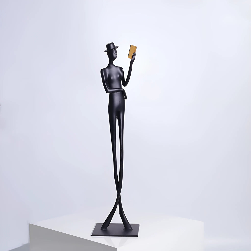 Black aluminium desktop sculpture of a woman reading, modern style.