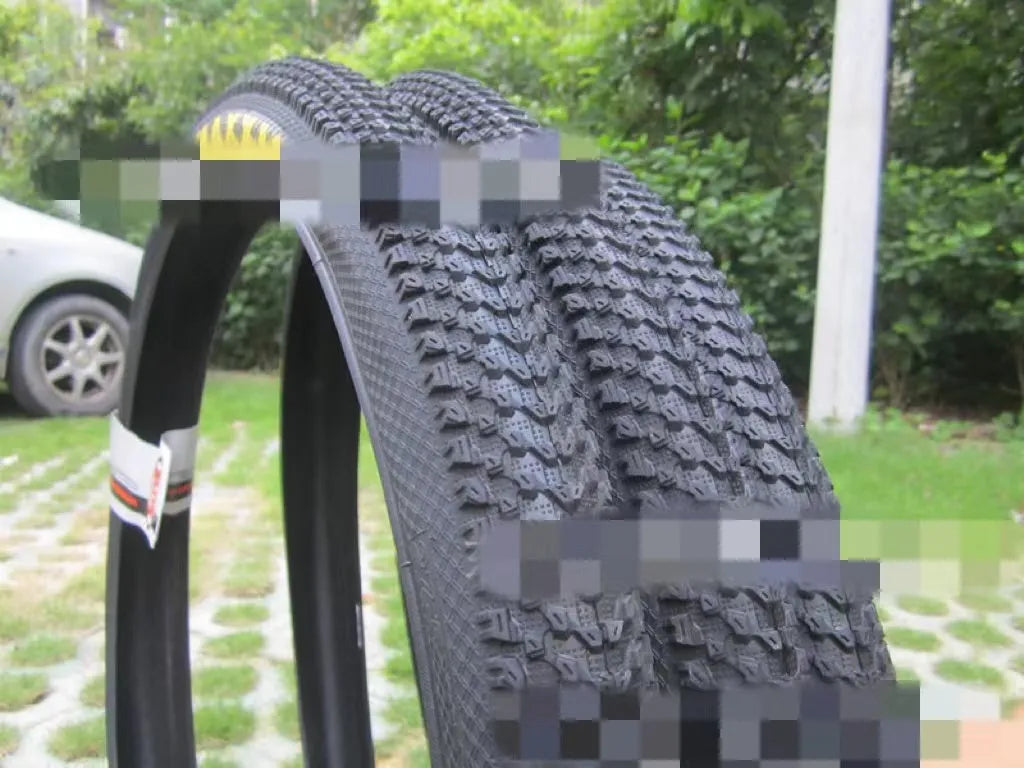 Ultralight mountain bike tyre with knobbly tread, shown in multiple size options including 26, 27.5 and 29 inch.