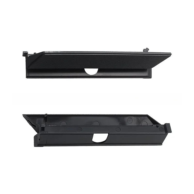 Black PS4 Pro hard drive bottom cover and small plastic repair parts including a baffle and strip.