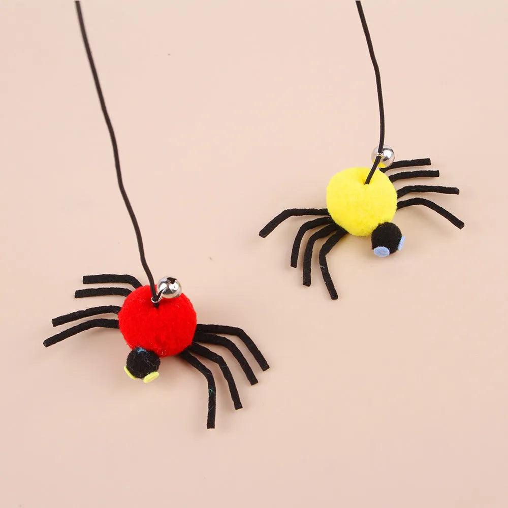 Hanging cat toy with red elastic rope, feather, and bell spider attachment mounted on door