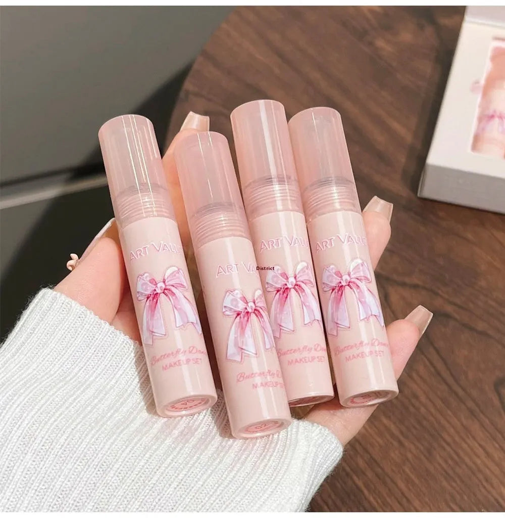 Butterfly Box makeup set showing four pink lip muds, a powder blusher, and a necklace