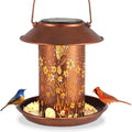 Solar garden lamp and bird feeder with hummingbird design made of iron art.