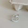 Geometric open ring with three-dimensional interlaced metal and matte electroplated finish in gold or silver colour