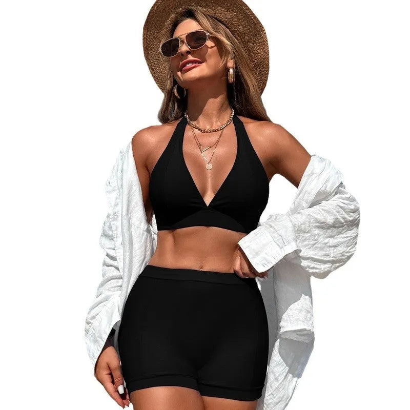 Women's black split bikini swimsuit made from nylon with polyester lining.