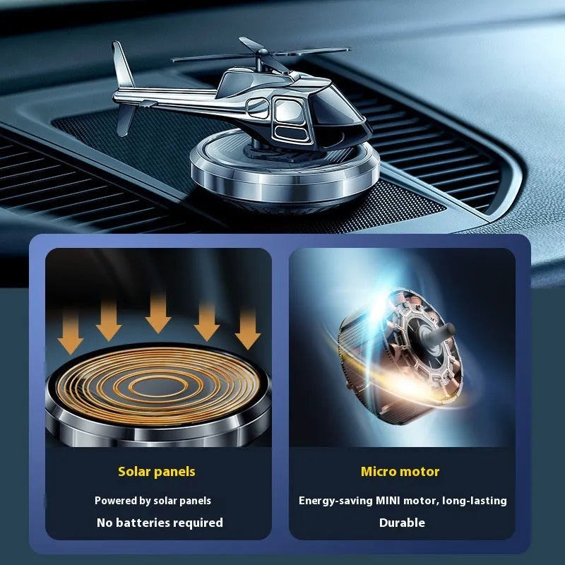 Silver metal solar helicopter car perfume ornament with rotating blades on car dashboard
