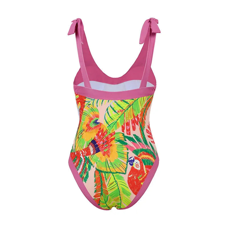 Pink floral retro one-piece swimsuit for women with V-neck and attached skirt on a hanger.