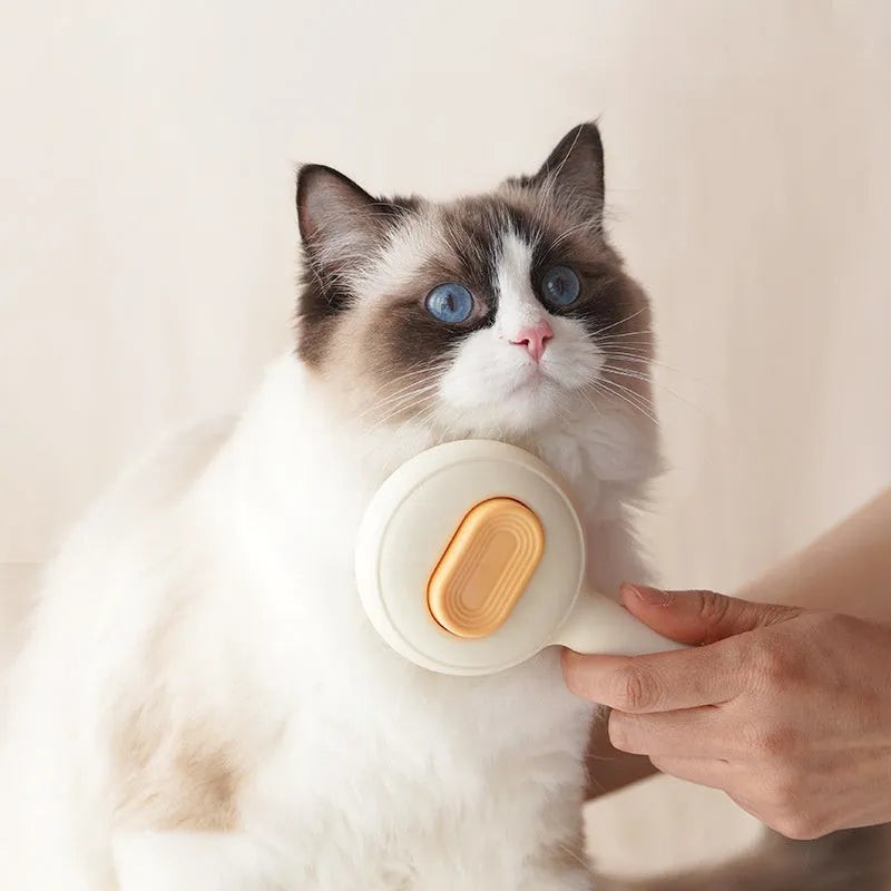 Green and yellow cat grooming brush with stainless steel comb and non-slip handle on a white background.
