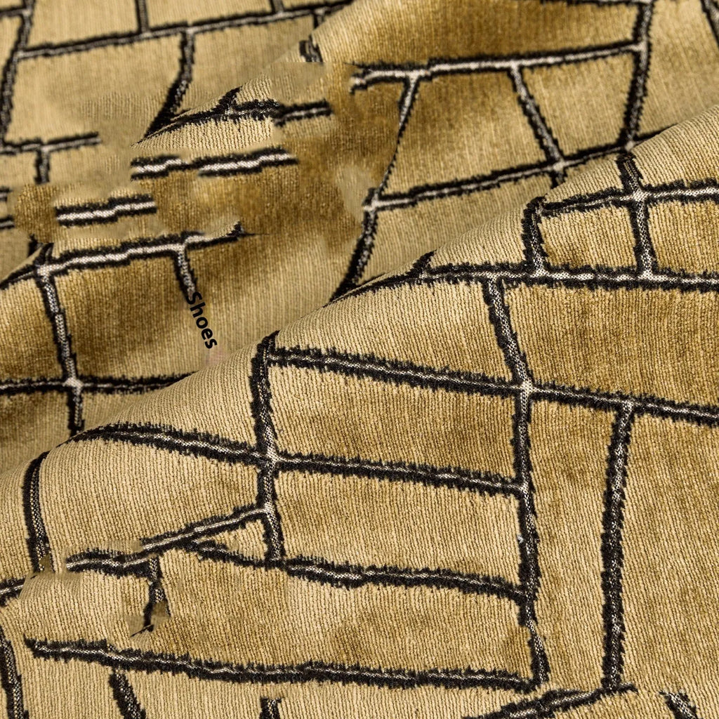 Gold geometric pattern polyester pillow cover shown in square and waist pillow sizes on a grey sofa.