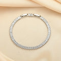 Rectangular geometric women's bracelet with full diamond zircon treatment in champagne gold colour