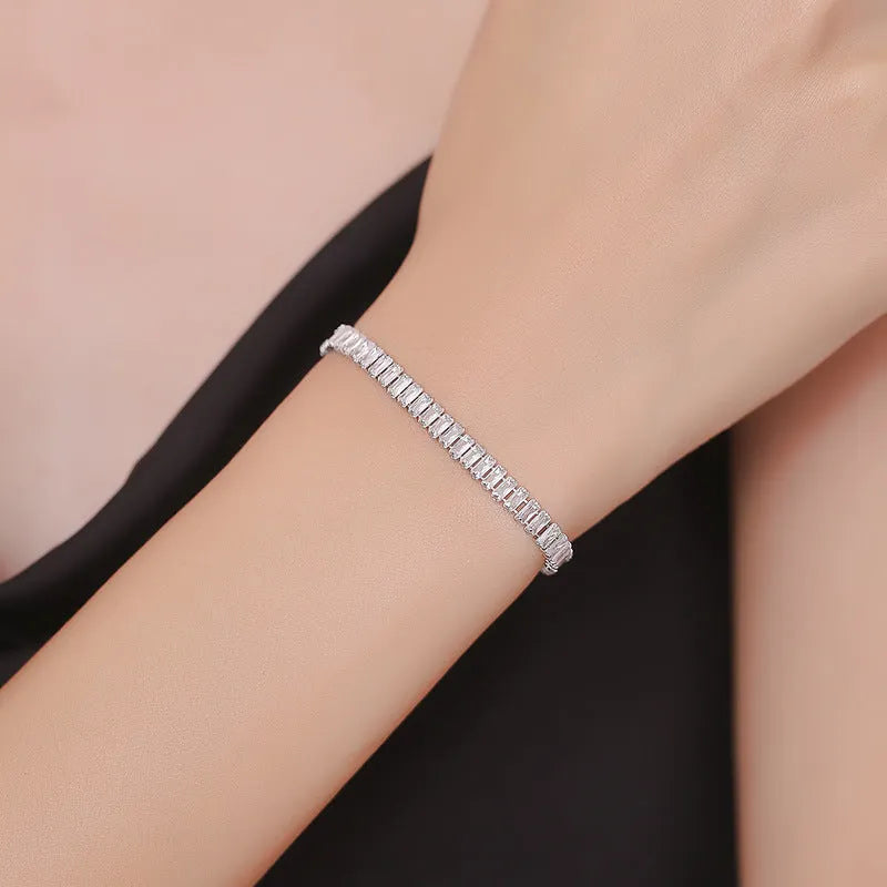 Rectangular geometric women's bracelet with full diamond zircon treatment in champagne gold colour