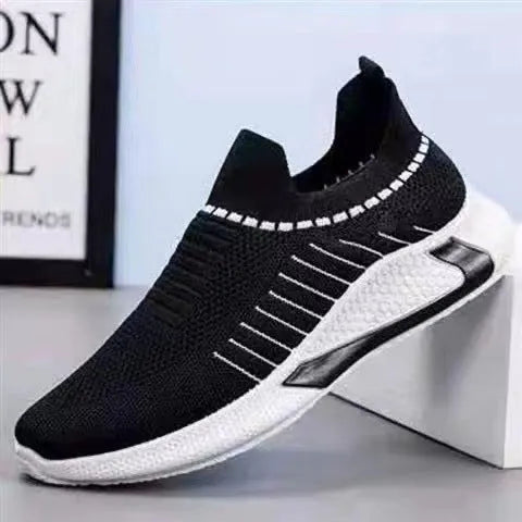 Men's black and white striped mesh slip-on sneakers with lace-up front on a plain background.