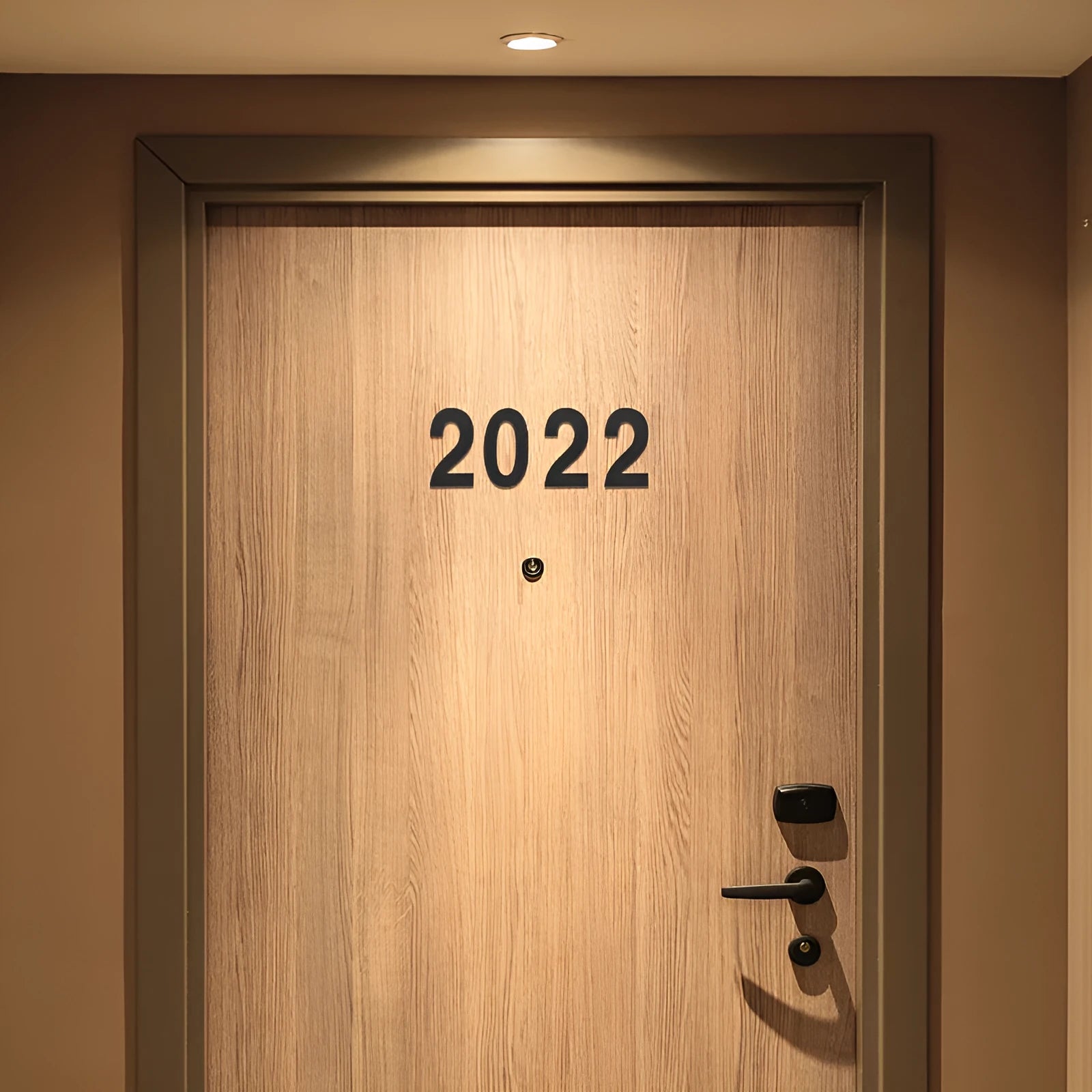 Black stainless steel adhesive house number sign showing digit 7, 7.5cm tall on adhesive backing.