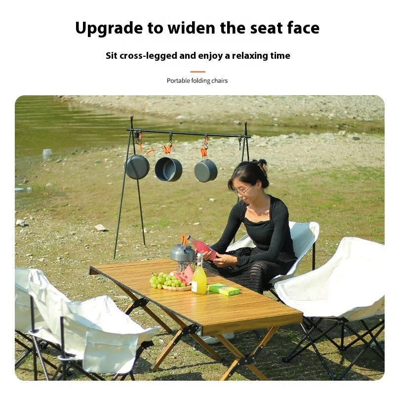 Beige folding camping chair with steel frame and Oxford cloth seat in outdoor setting