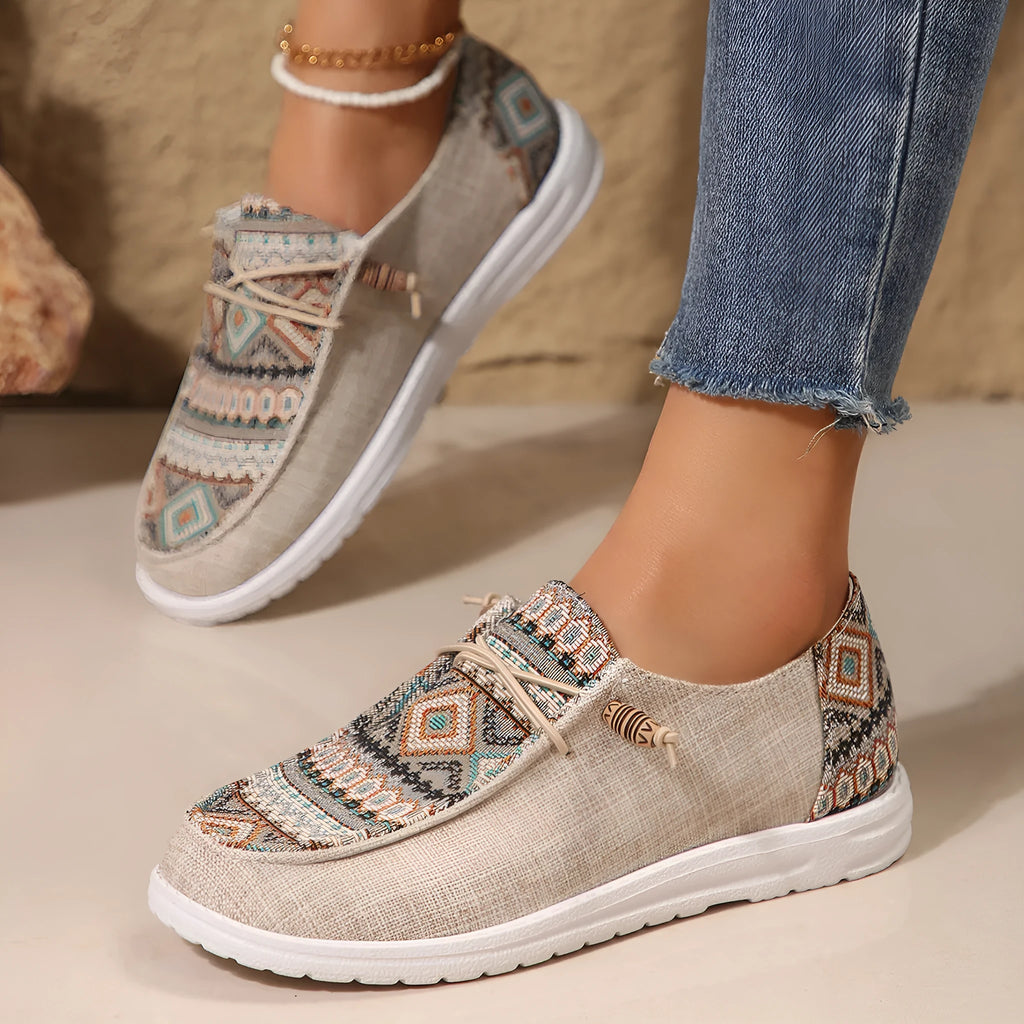 Women's low-top flat slip-on shoes in black with a round toe and rubber sole.