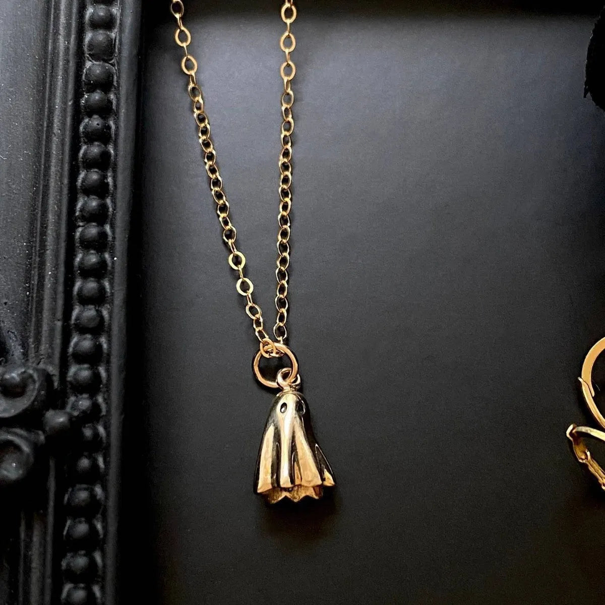 Ghost pendant necklace with twisted stainless steel chain, shown in available chain style options.