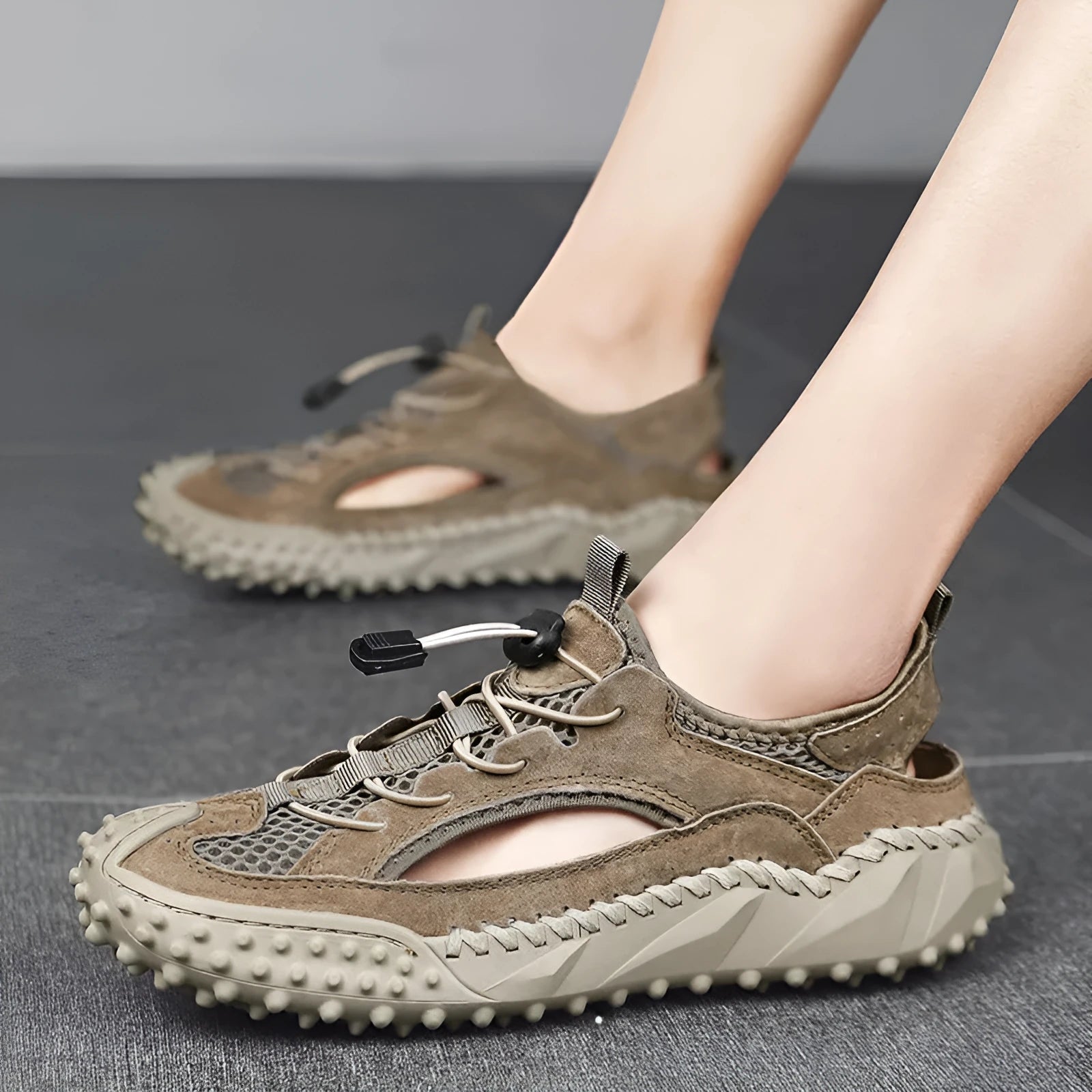 Men's black sports sandals with leather mesh upper, elastic band and non-slip rubber sole.