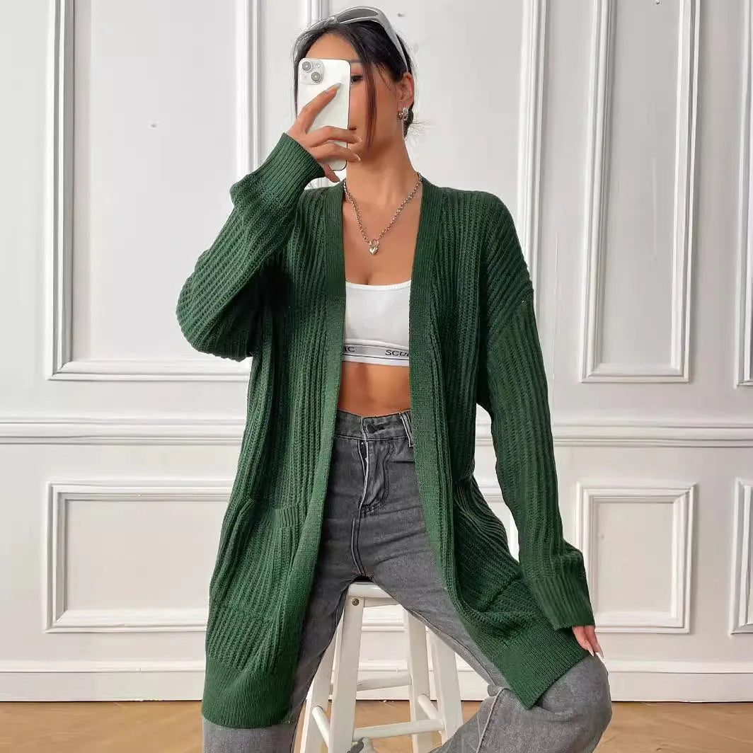 Womans loose fit acrylic cardigan sweater in dark green, showing mid-length and long sleeves.