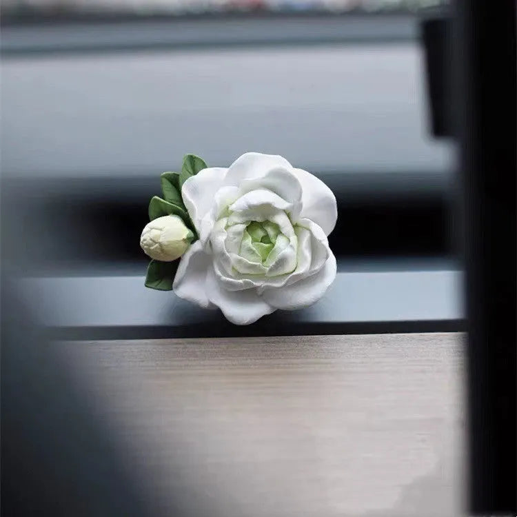 Jasmine solid car perfume gypsum tablet clipped to a car air vent.