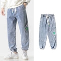 Men's loose-fit tapered cotton trousers in black, blue, or grey with mid waist design