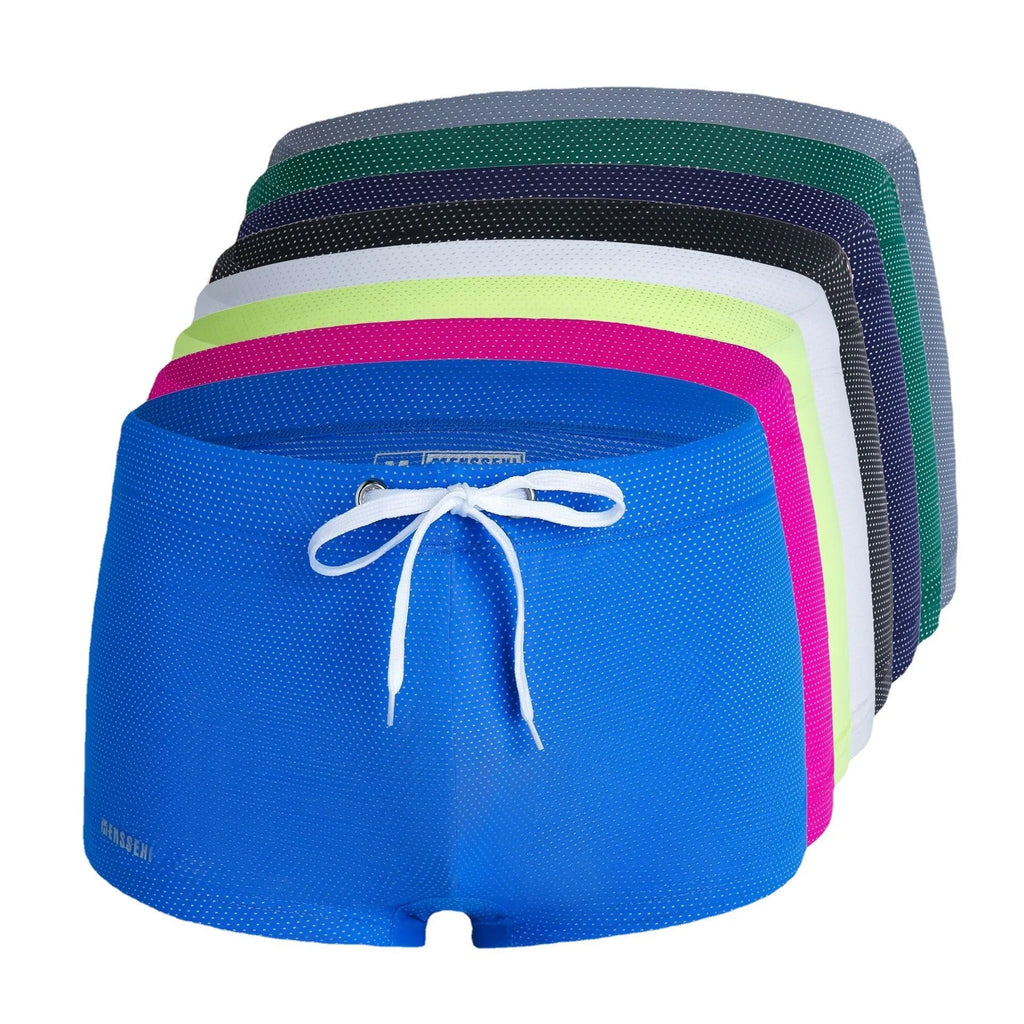 Men's solid colour nylon boxer swimming trunks with a low waist design on a white background.