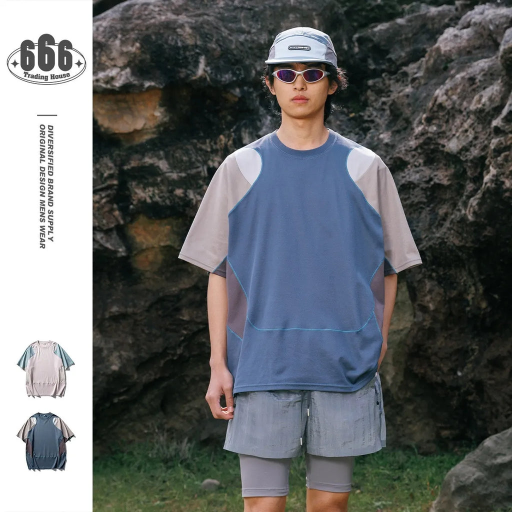 Men's loose blue patchwork contrast short sleeve cotton blend t-shirt on a hanger.