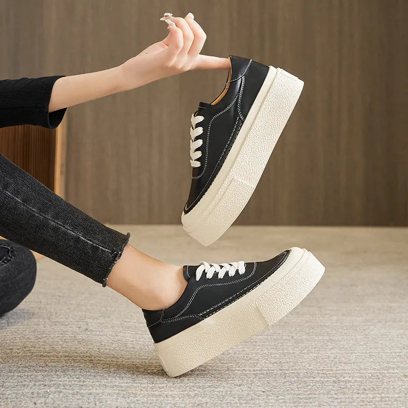 Women's black embossed cowhide leather platform sports board shoes with a round toe and white rubber sole.