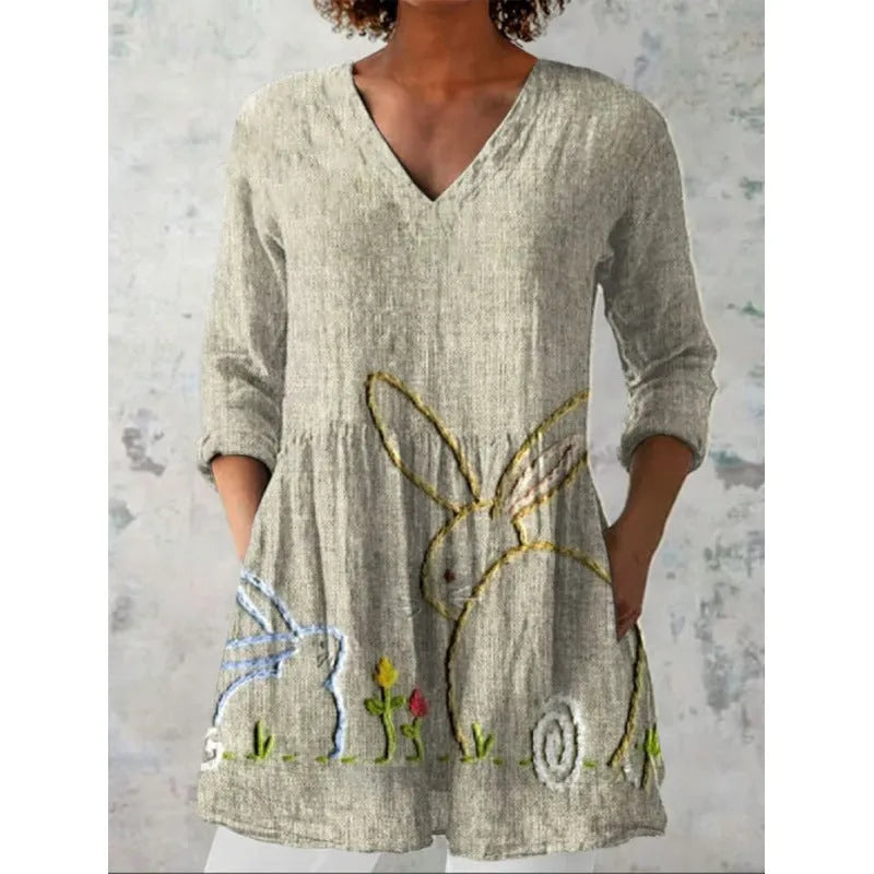 Women's printed loose wave dress with 3/4 sleeves and a wide waist on a hanger.