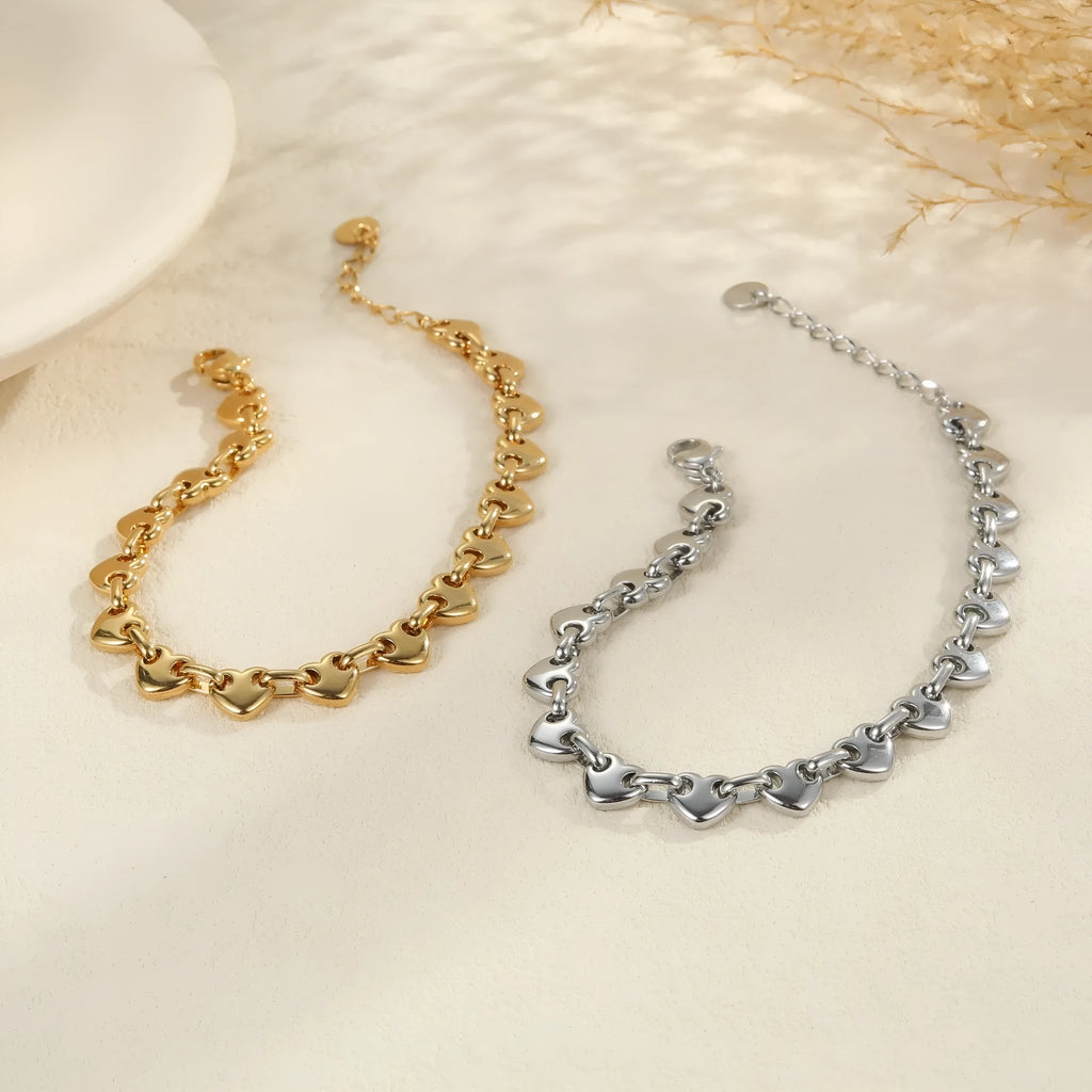 Women's stainless steel bracelet with a hollowed-out geometric heart charm in a gold-plated finish.