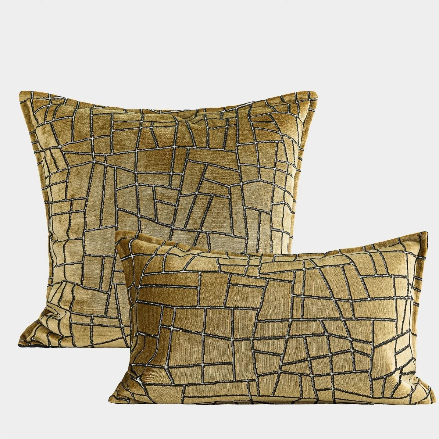 Gold geometric pattern polyester pillow cover shown in square and waist pillow sizes on a grey sofa.