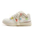 Creamy white retro skate shoes with low platform sole and lace-up design