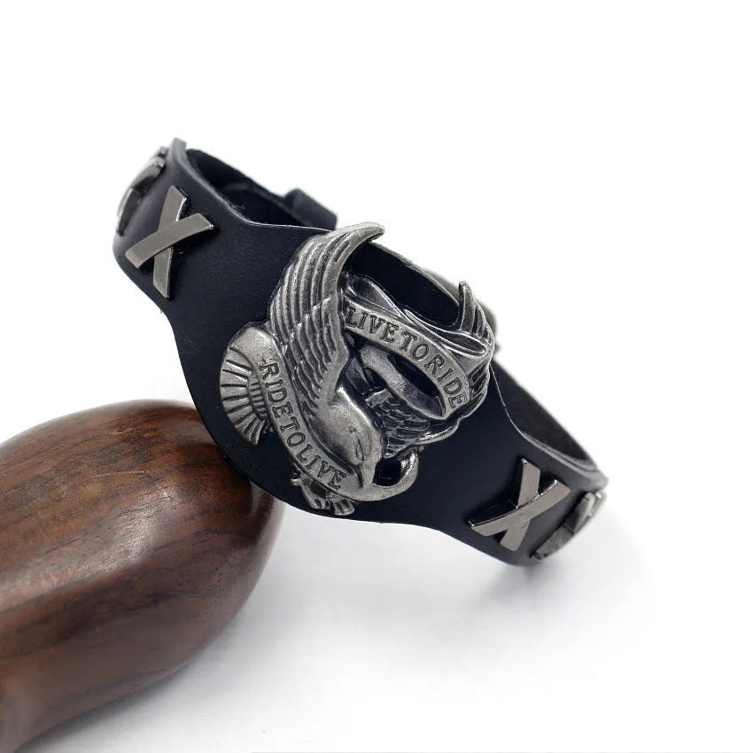 Geometric black leather bracelet with alloy eagle detailing showing tapered width design