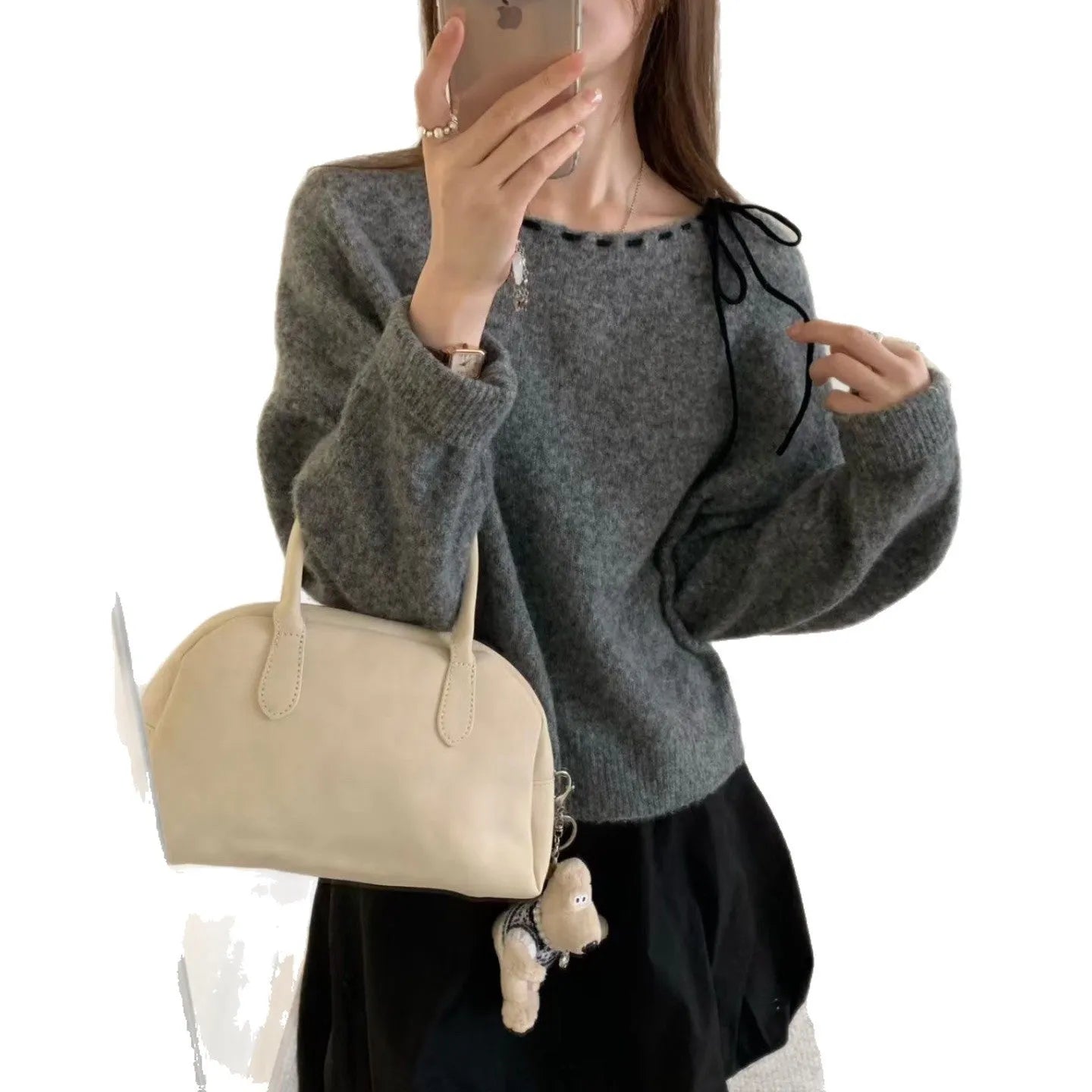 Women's loose grey knitwear pullover showing front view and relaxed fit