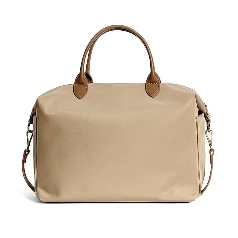 Black nylon waterproof shoulder bag with leather trim, showing large main compartment and shoulder strap.